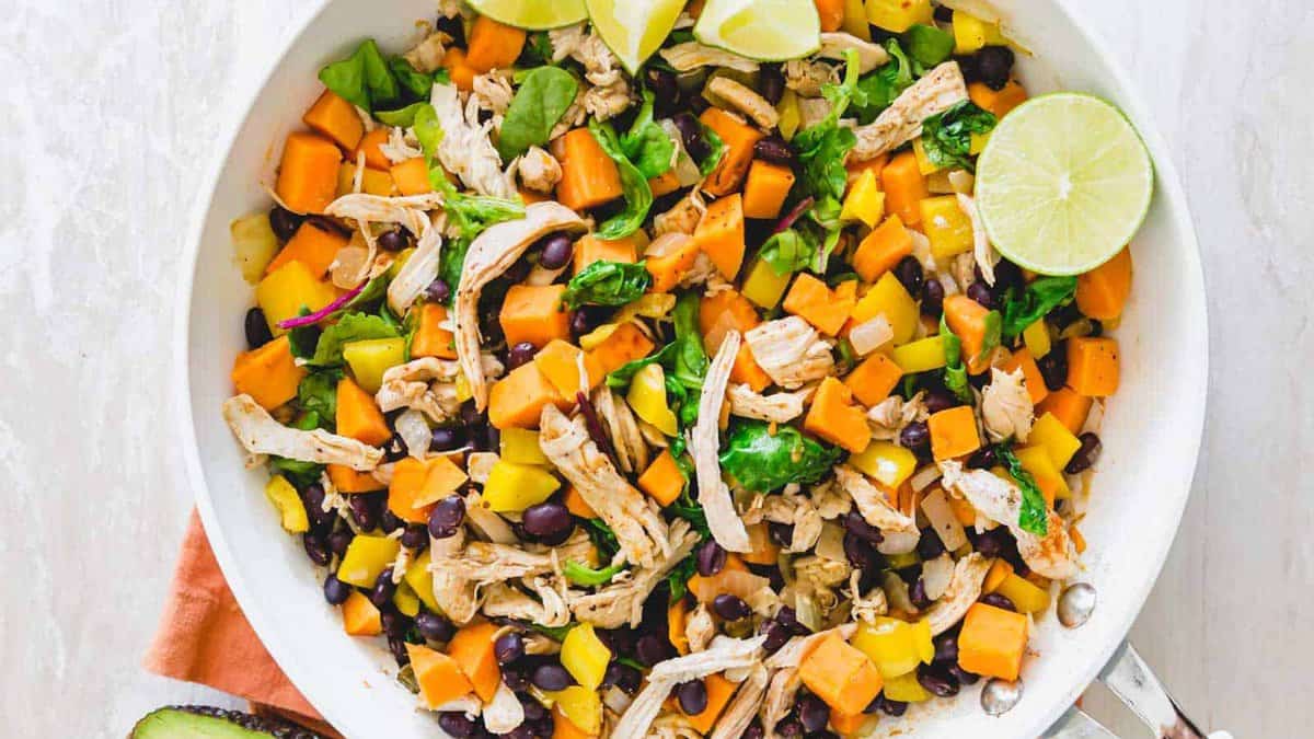 Turkey and sweet potato cooked together in a skillet.