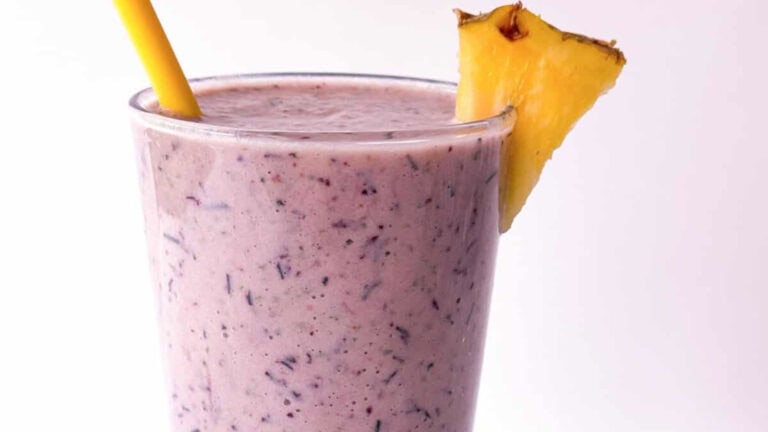 A colorful smoothie featuring juicy pineapple and blueberries, perfect for a refreshing and healthy treat.
