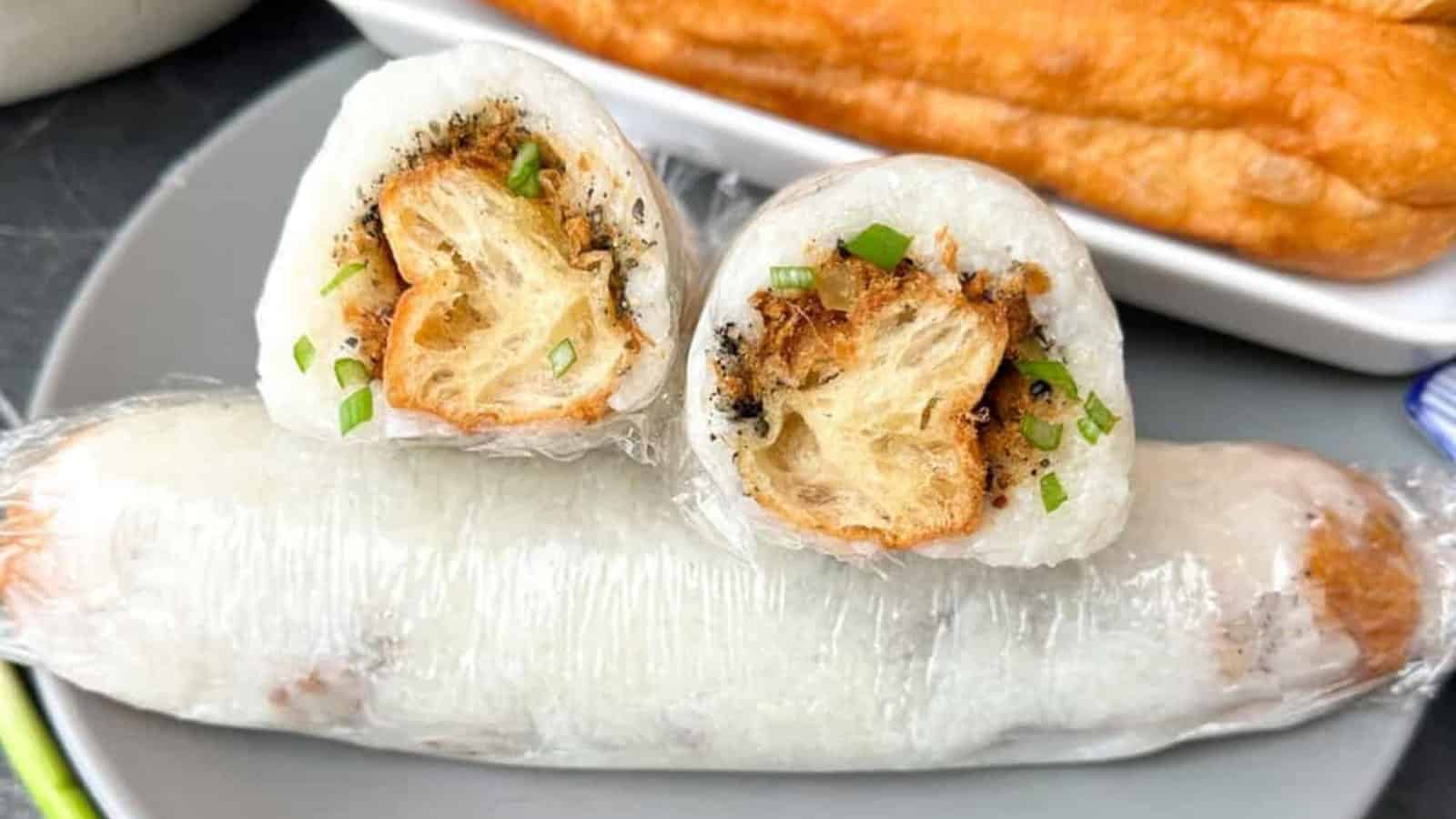Savory Chinese stuffed sticky rice rolls on a plate.