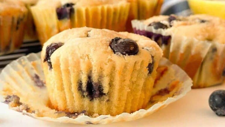 Freshly baked Starbucks blueberry muffin arranged on a white plate.