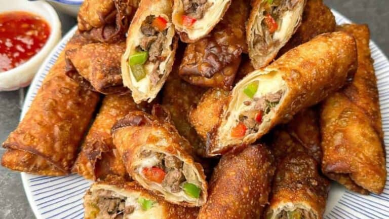 Crispy egg rolls stuffed with cheesy Philly cheesesteak filling.