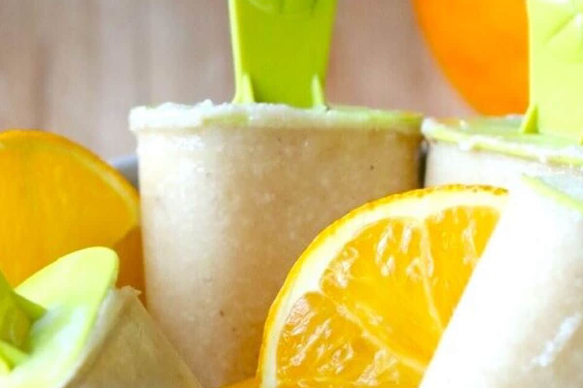 Cashew Milk Creamsicles in a bowl with sliced orange.