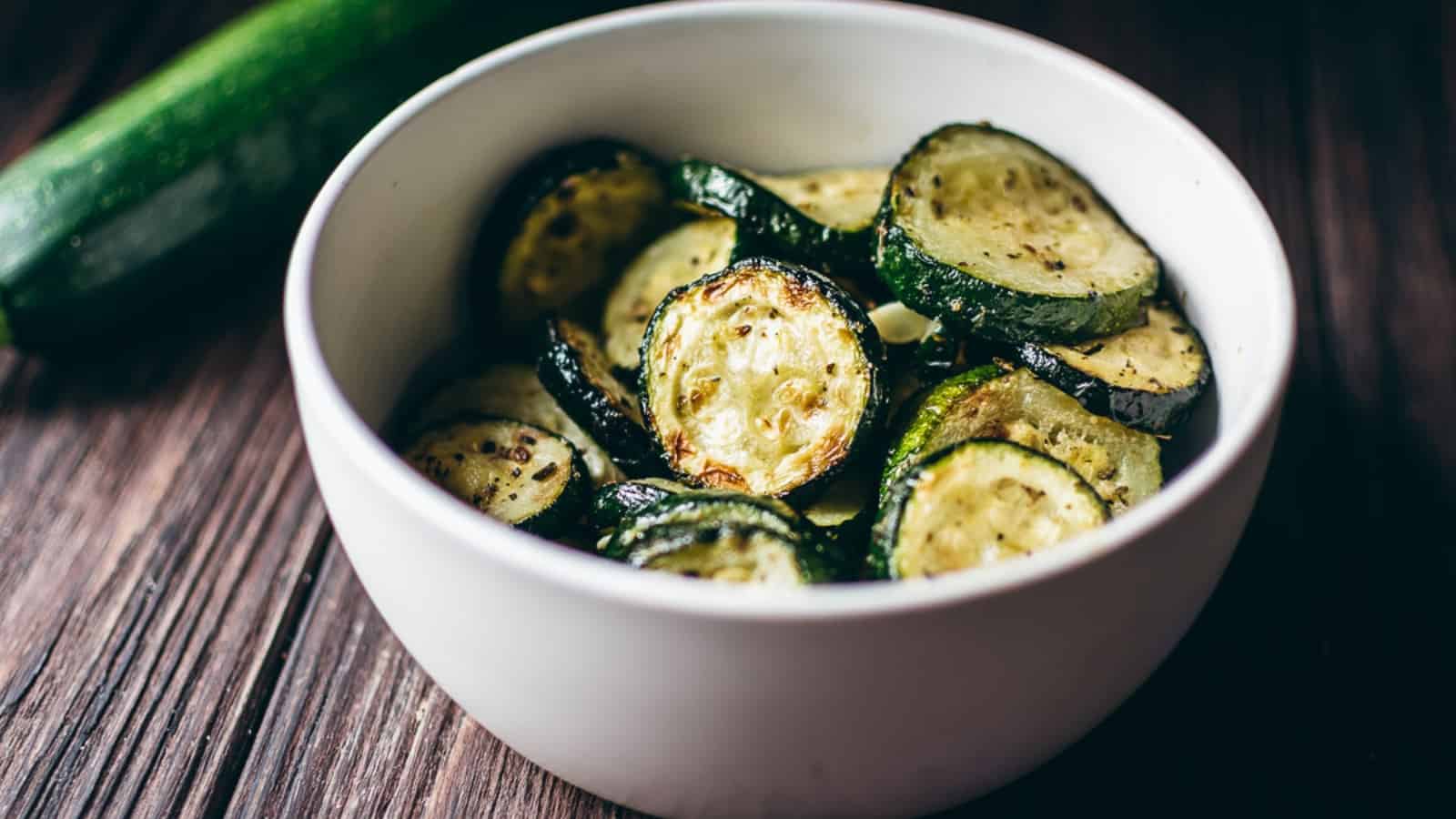 Crispy, golden-brown air fryer zucchini slices served in a bowl.