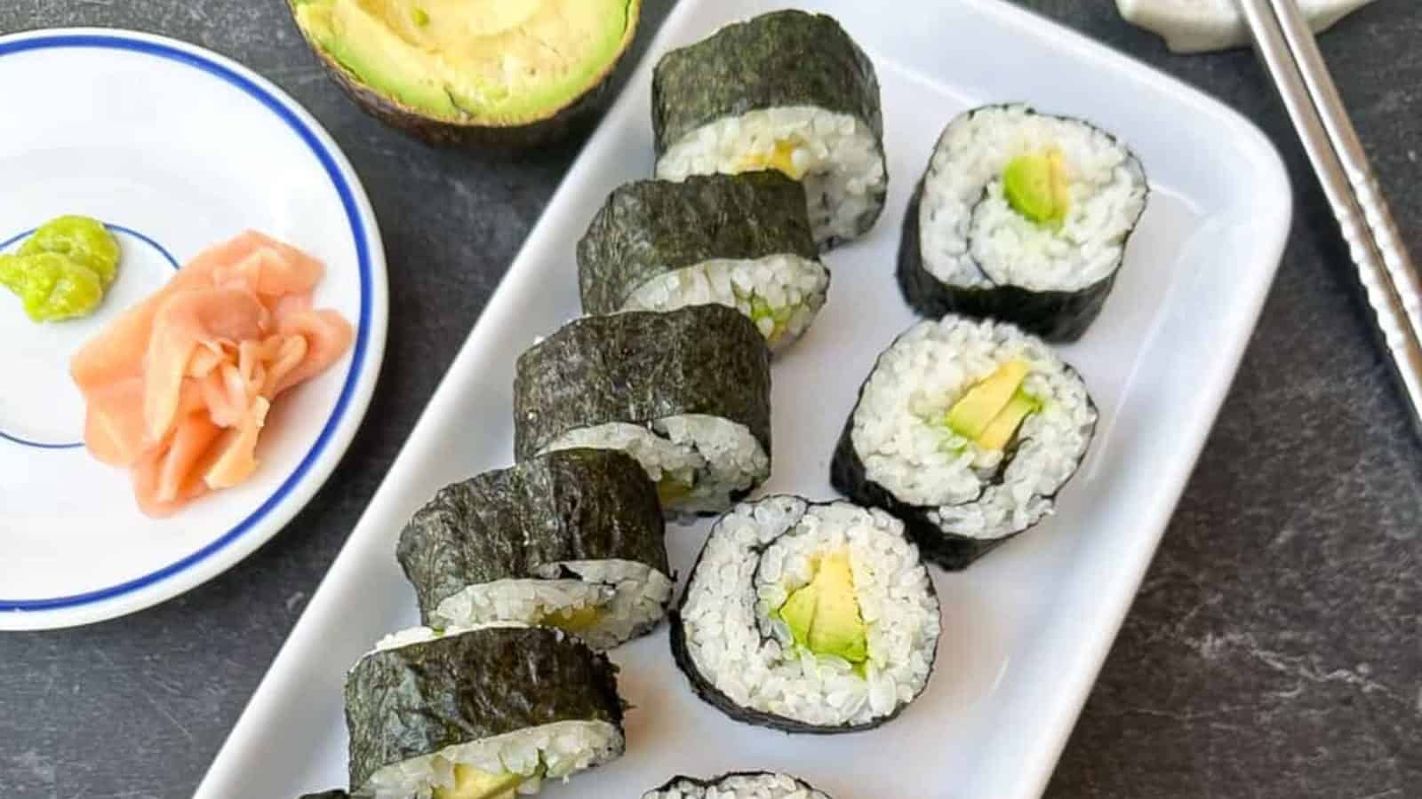Fresh and vegan-friendly avocado maki sushi rolls on a plate.