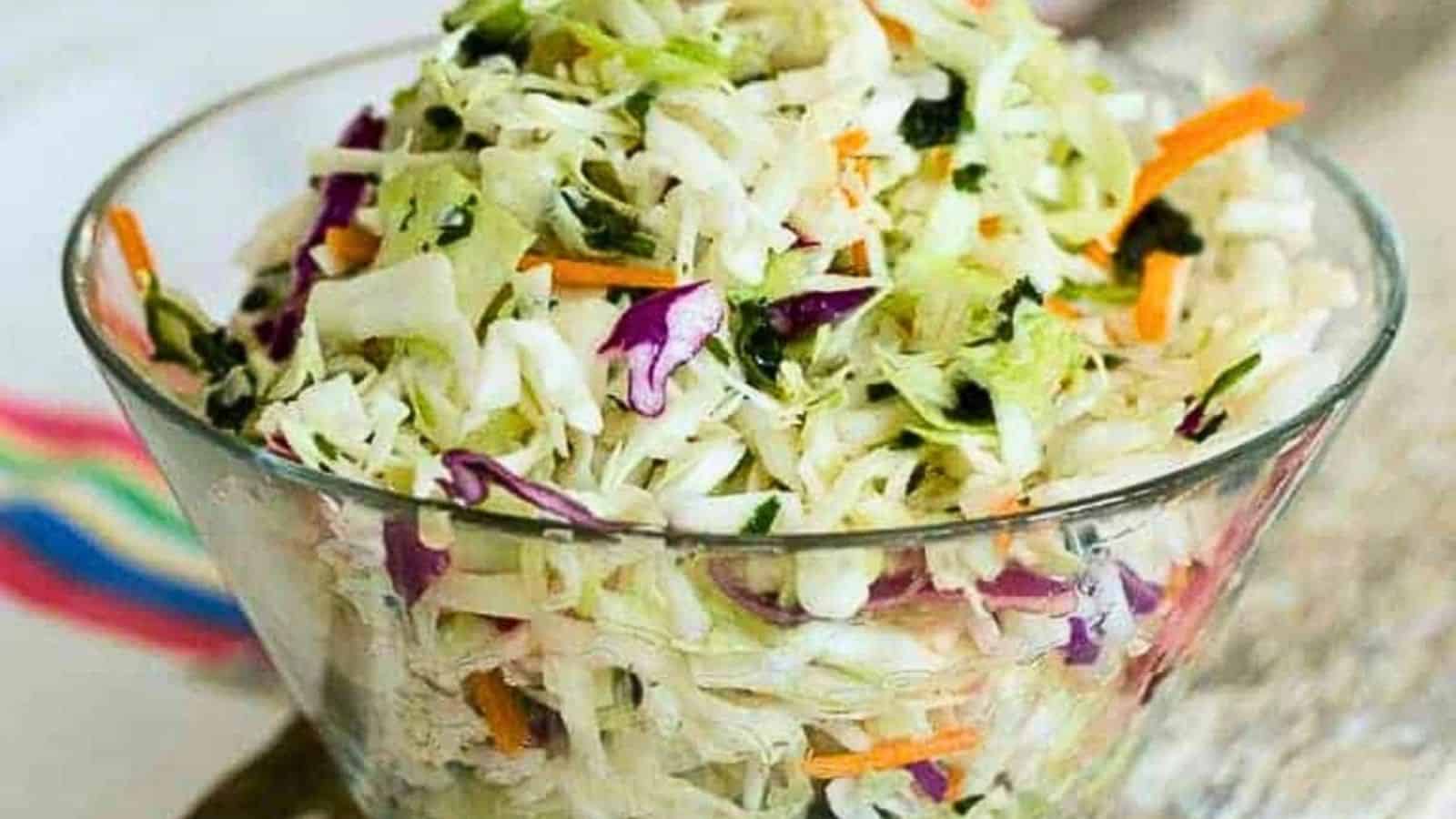 A bowl of Mexican coleslaw salad with colorful shredded cabbage.