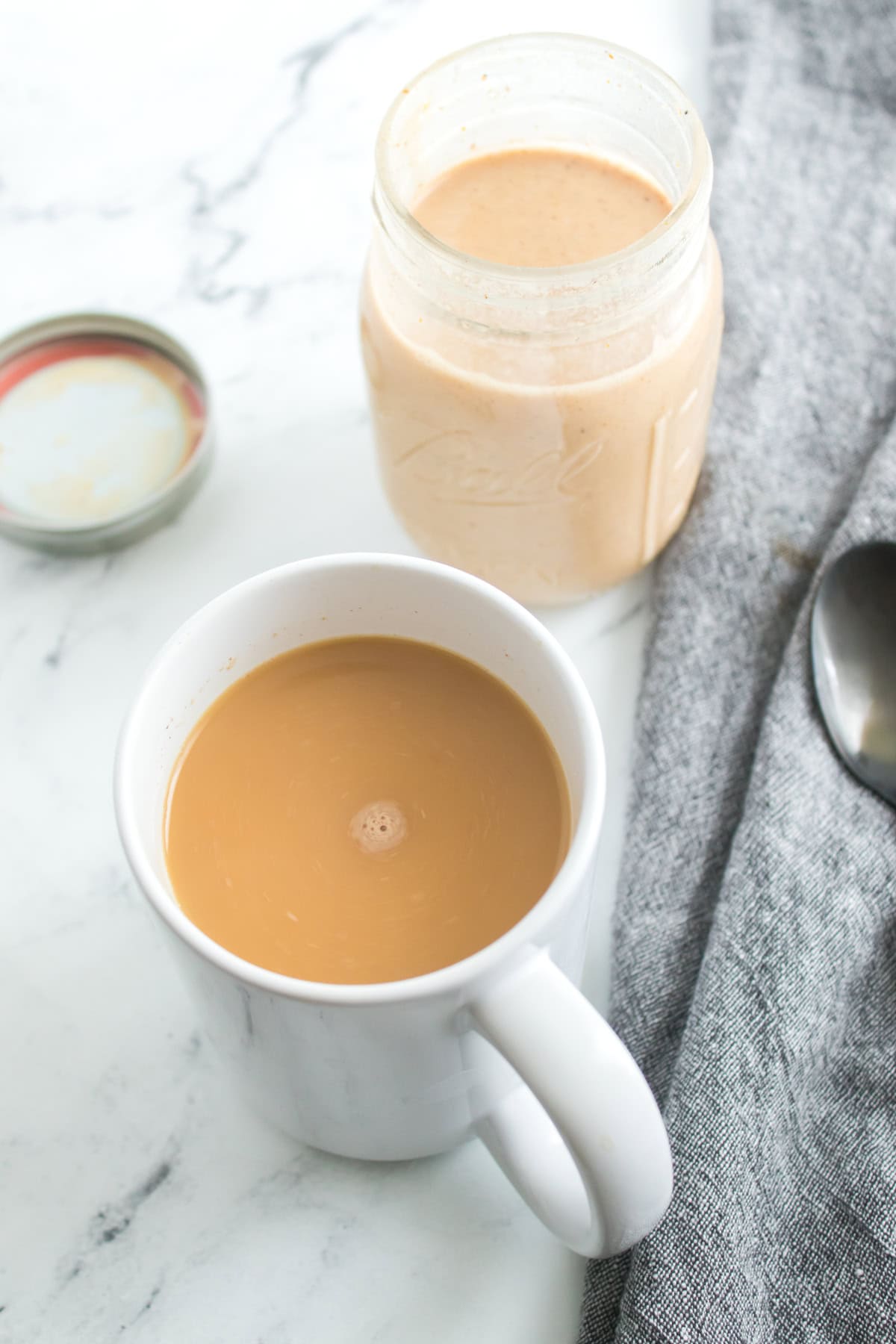 A cup of coffee filled with homemade pumpkin-flavored creamer.