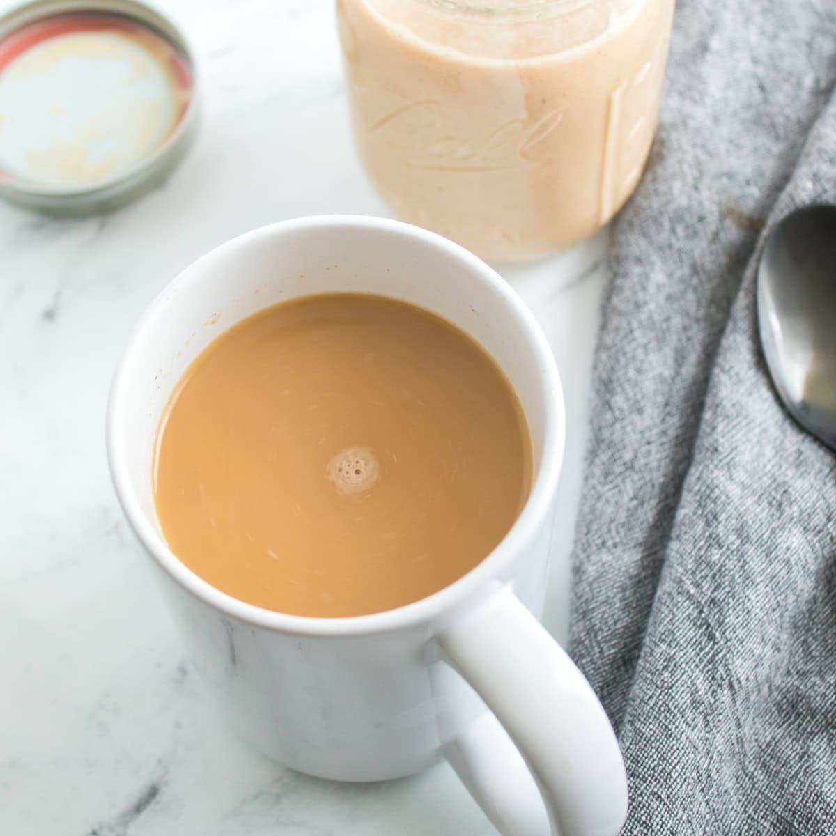 Homemade pumpkin spice coffee creamer in a white cup.