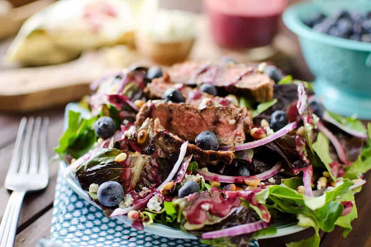 Salad with steak, pine nuts, and balsamic.