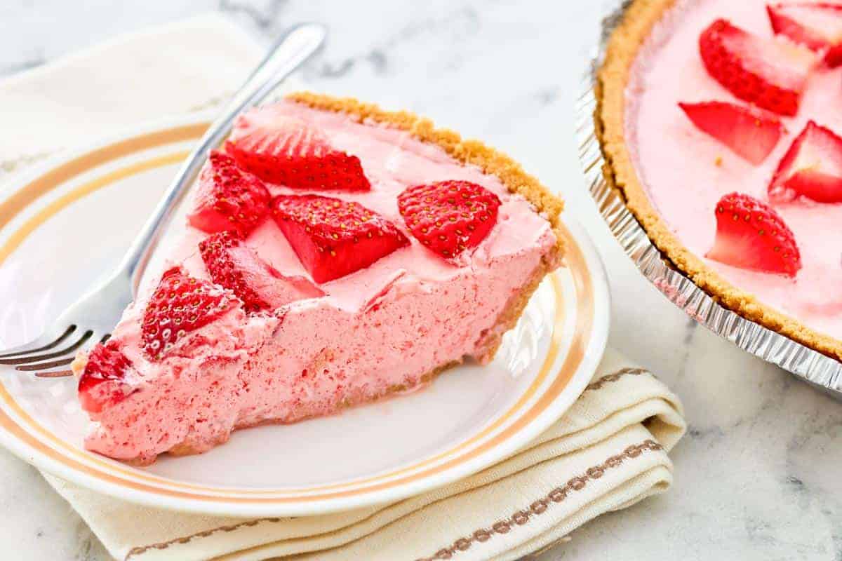 Classic strawberry Jello pie in a graham cracker crust, topped with fresh berries.