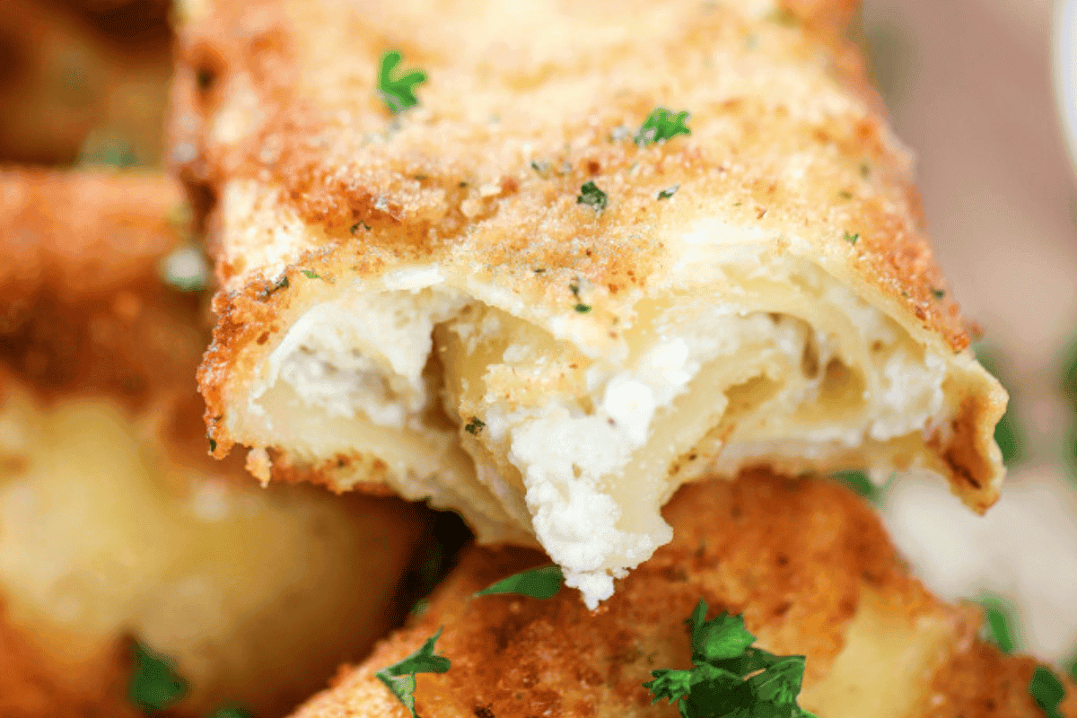 Breaded lasagna squares are deep-fried and topped with marinara and Parmesan.