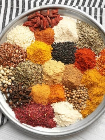 A pan filled with colorful spices and herbs.