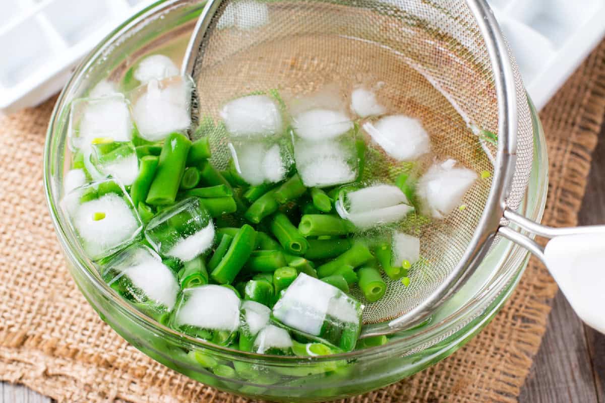 Blanching green bean in a bowl with ice,