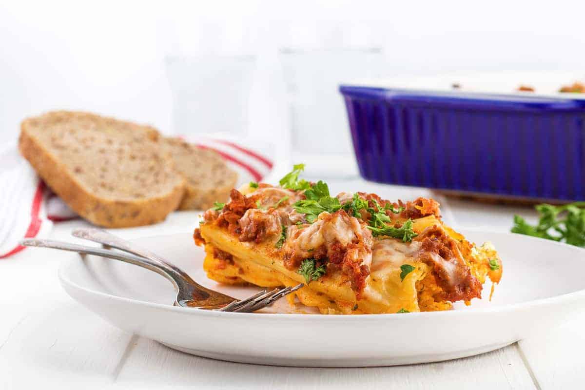 Baked manicotti pasta stuffed with ricotta, mozzarella, and Parmesan, smothered in marinara sauce.