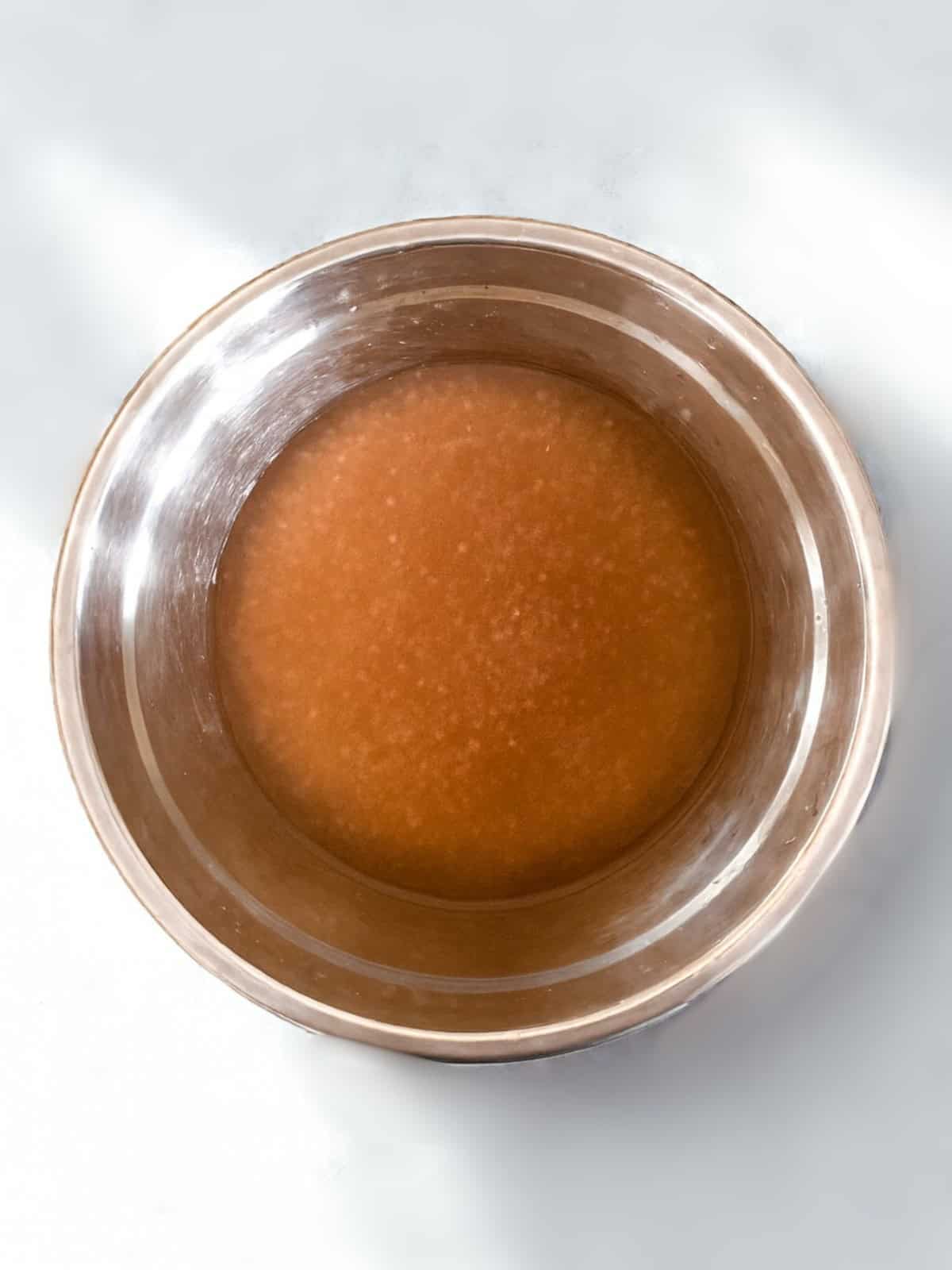 Cooked tapioca mixture in a stainless steel bowl, ready for mango sago.