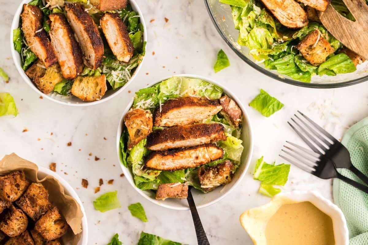 Blackened air fryer chicken over Caesar salad with crunchy croutons.