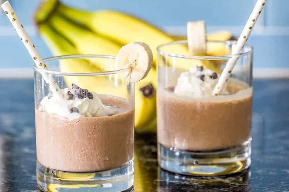 Chocolate banana smoothie with peanut butter drizzle and whipped cream.