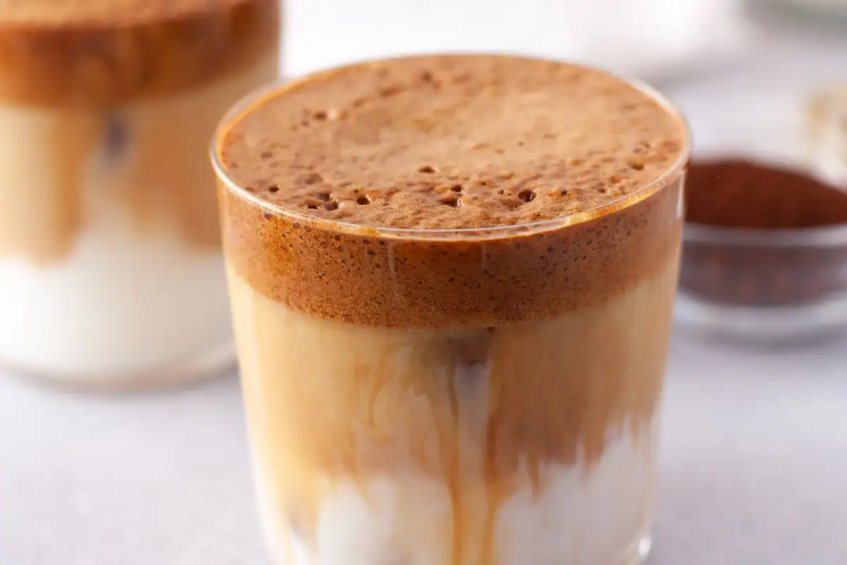 Fluffy whipped pumpkin coffee over milk.