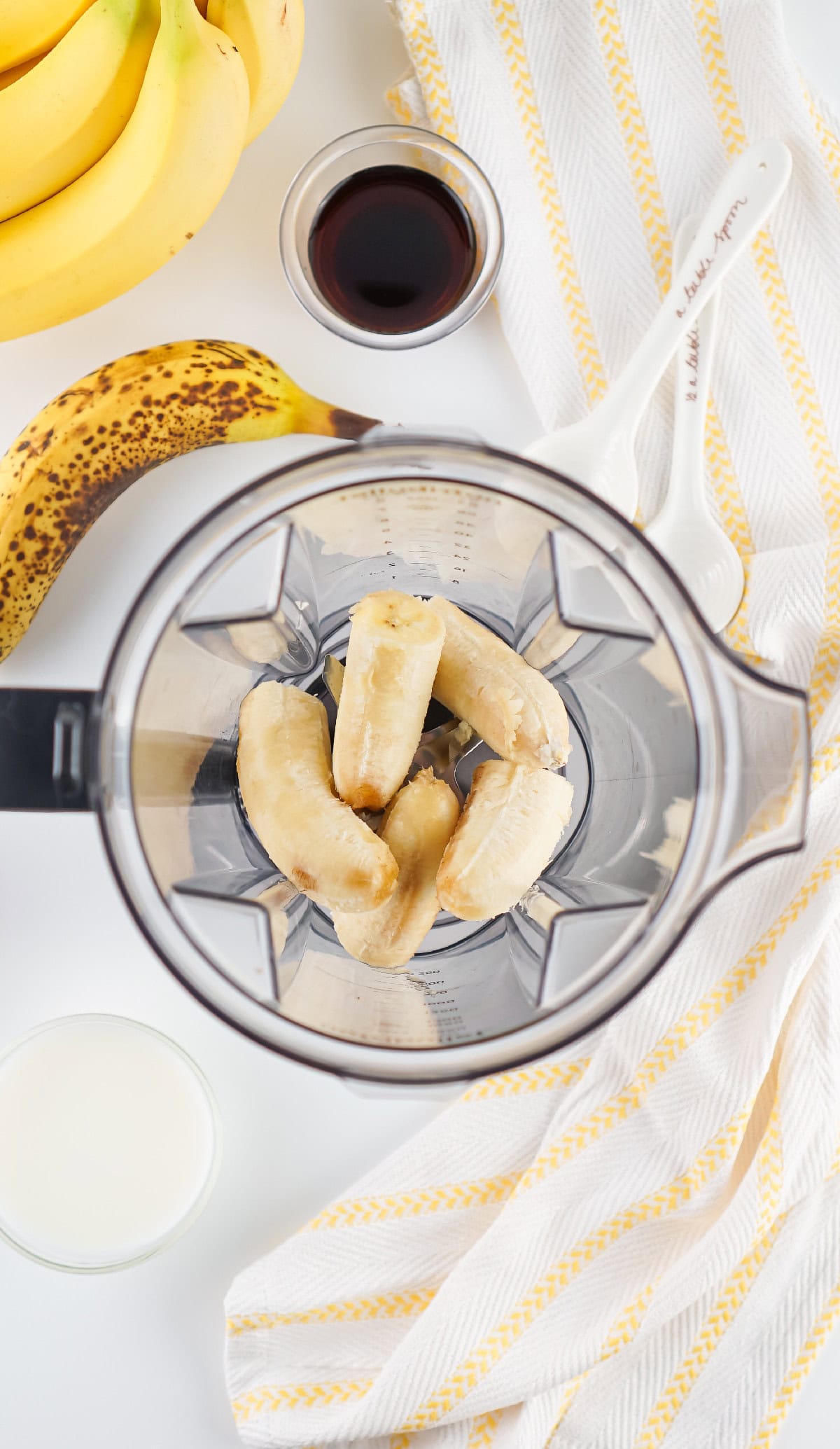 Bananas placed in a Nutribullet blender, ready to make banana milk.