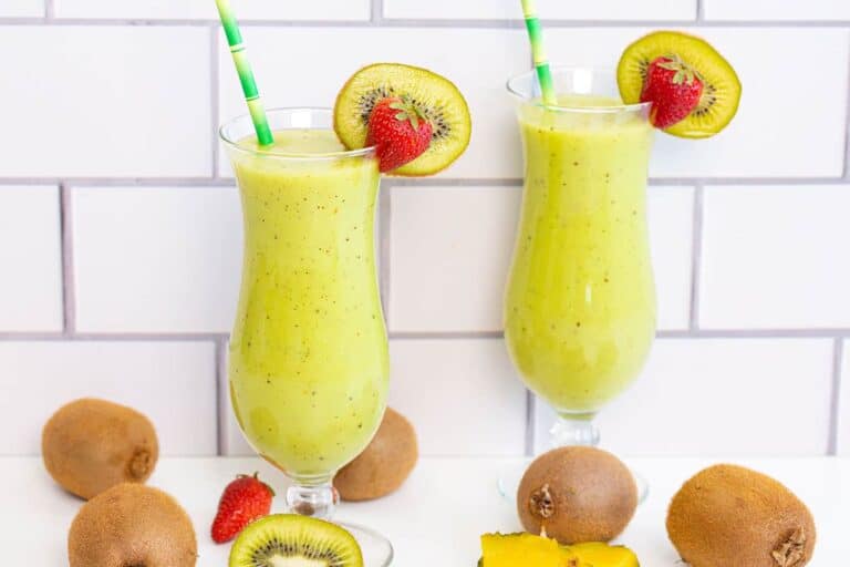 Bright green kiwi smoothie in glass.