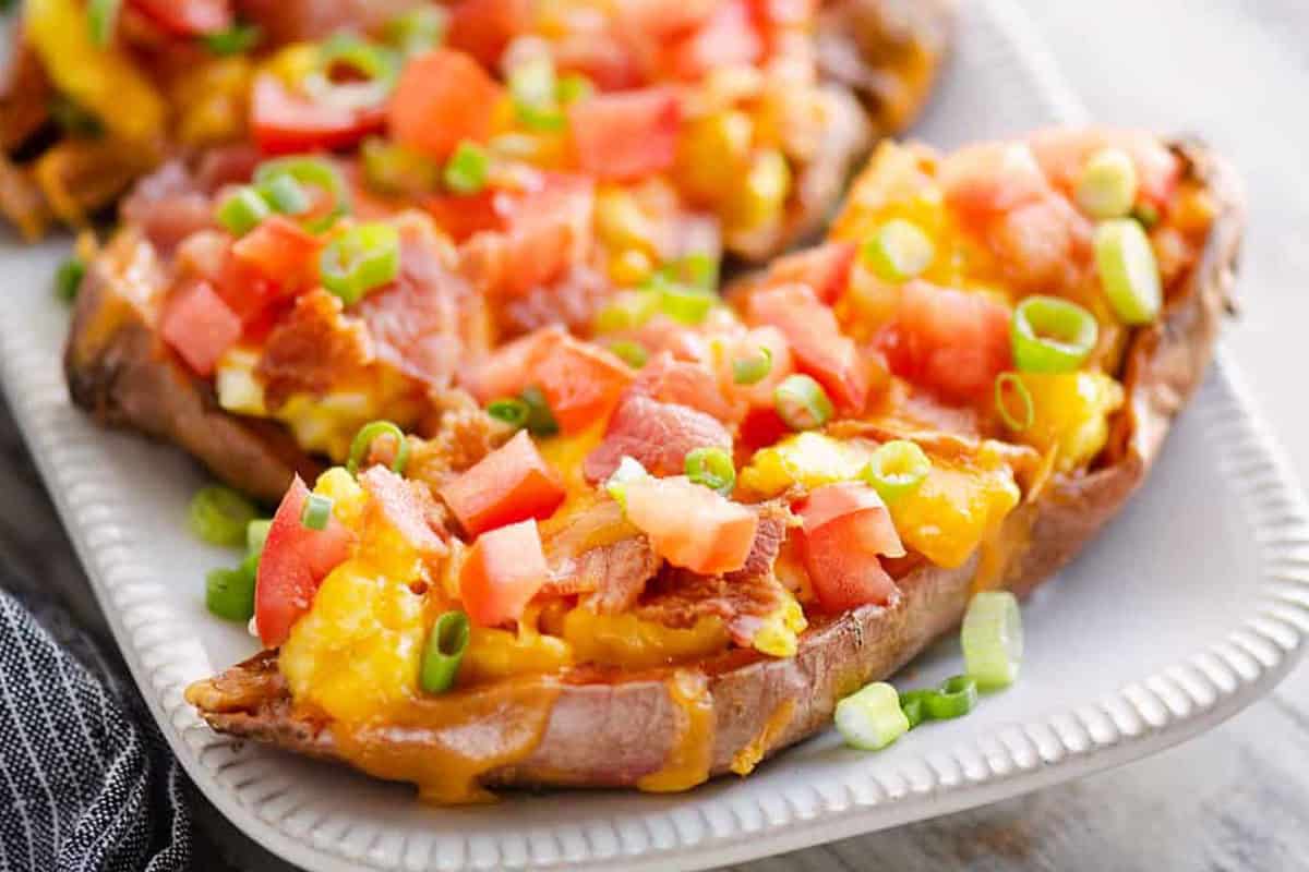 Loaded sweet potato skins with egg, cheese, and herbs.