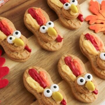 Nutter Butter cookies decorated with candy eyes, yellow candy beaks, and red and orange frosting to look like festive Thanksgiving turkeys.