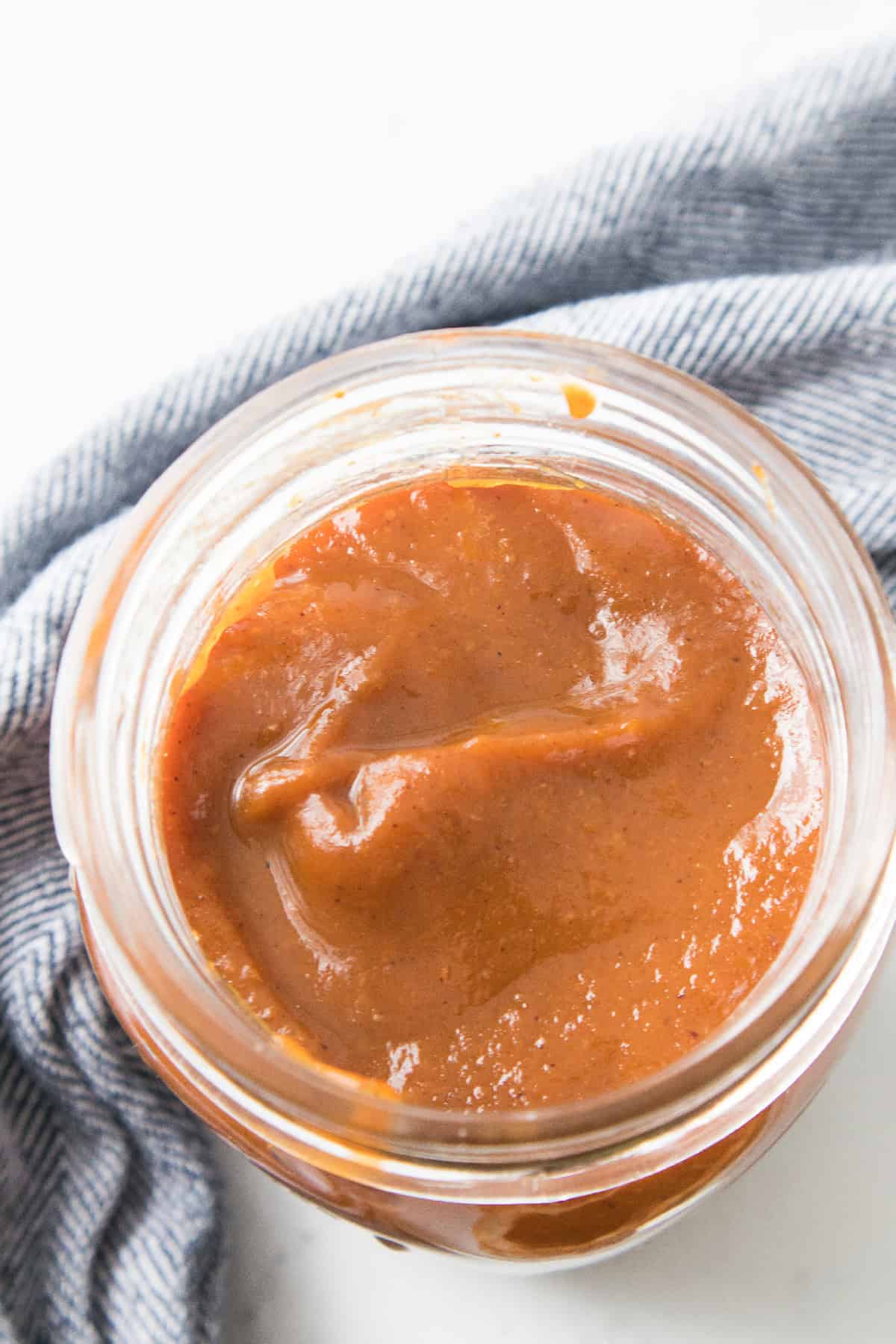 Close-up of a jar filled with smooth pumpkin butter.