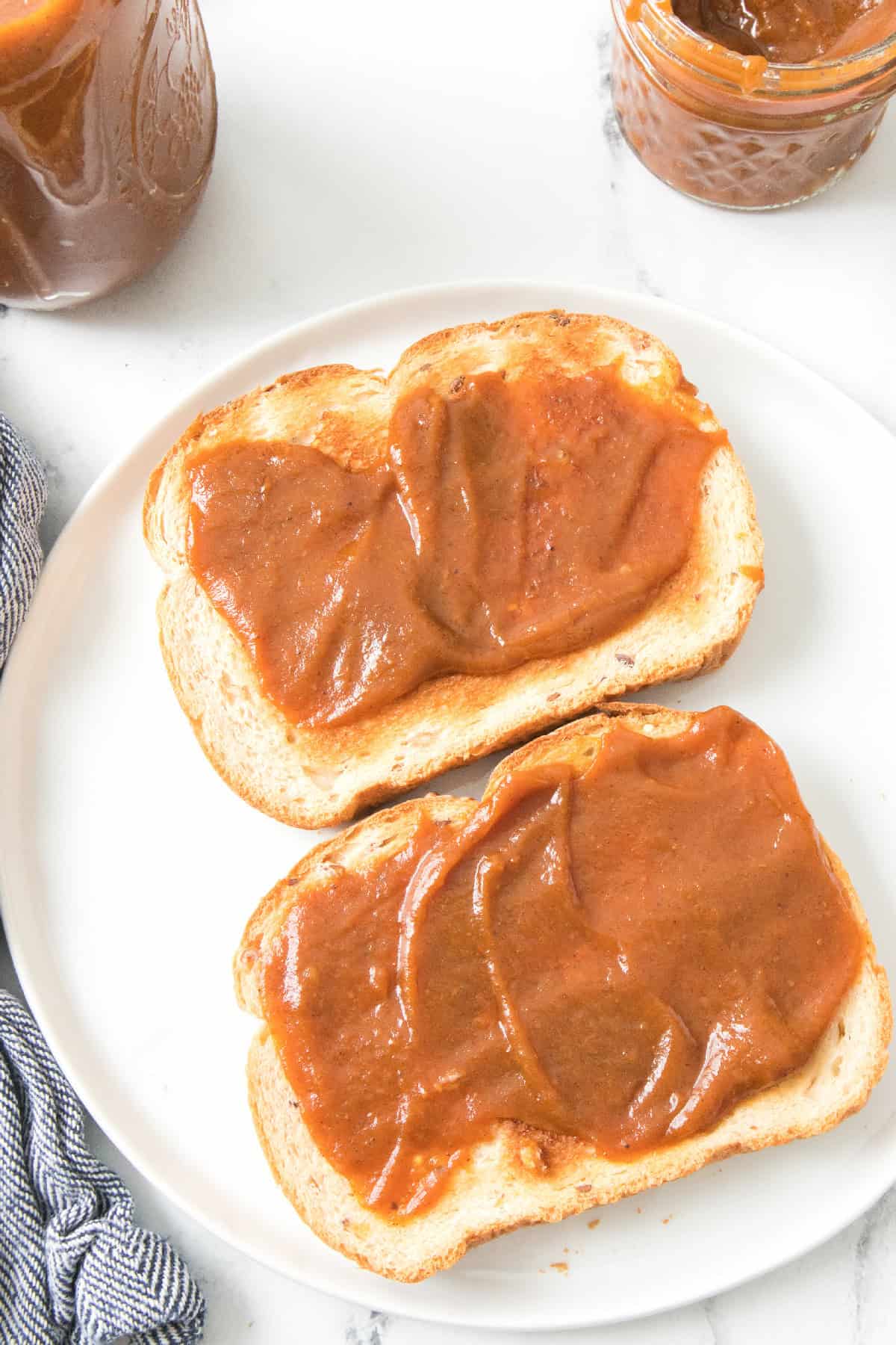 Overhead plate of toast generously spread with pumpkin butter.
