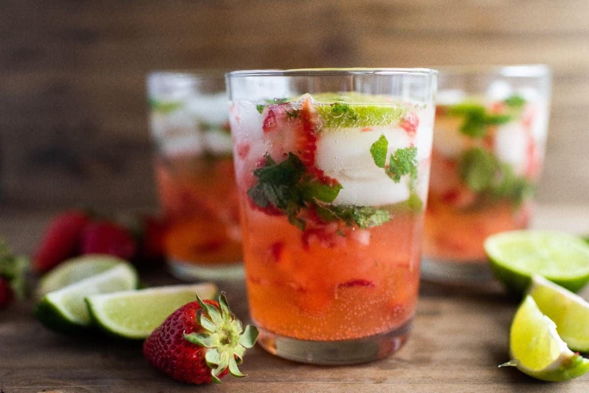 Mojito with strawberries, mint, and lime.