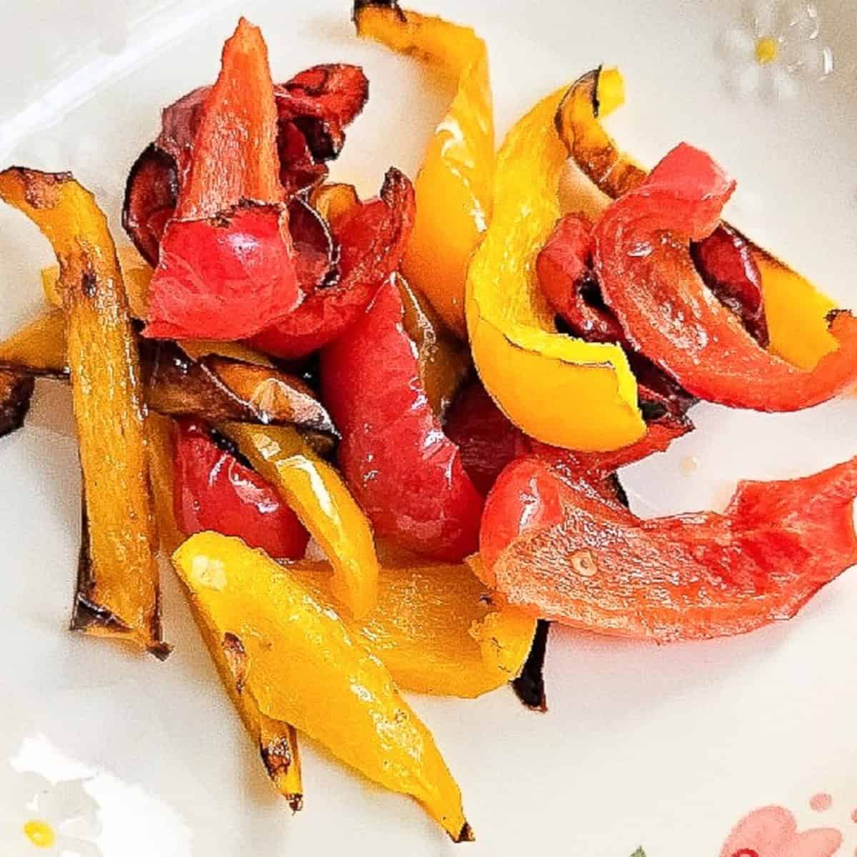 Golden yellow and red bell pepper strips with charred edges, cooked to perfection in the air fryer.