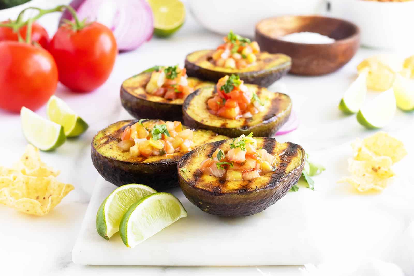 Charred avocado halves topped with fresh pico de gallo.