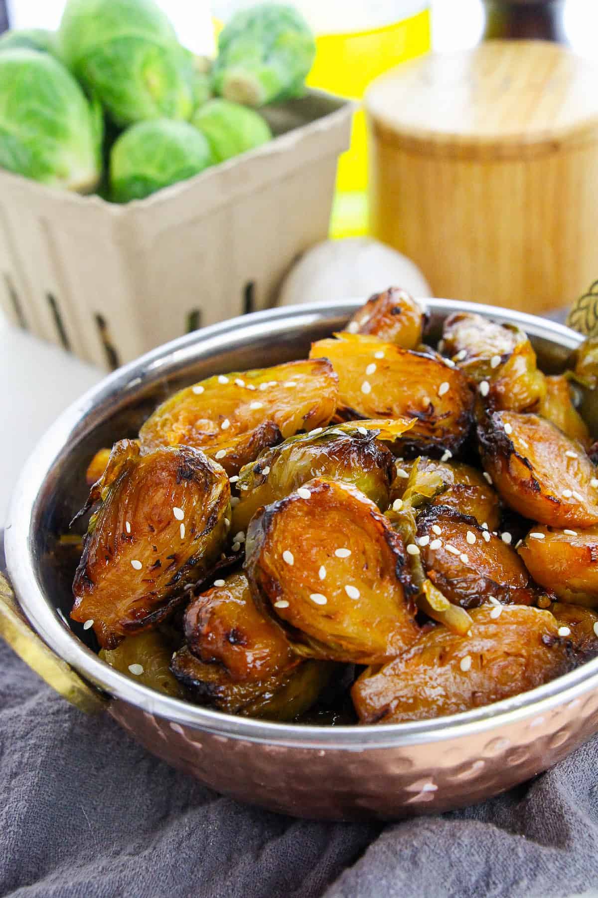 Horizontal shot of Korean Brussels sprouts in a bowl, showcasing crispy texture and caramelization.