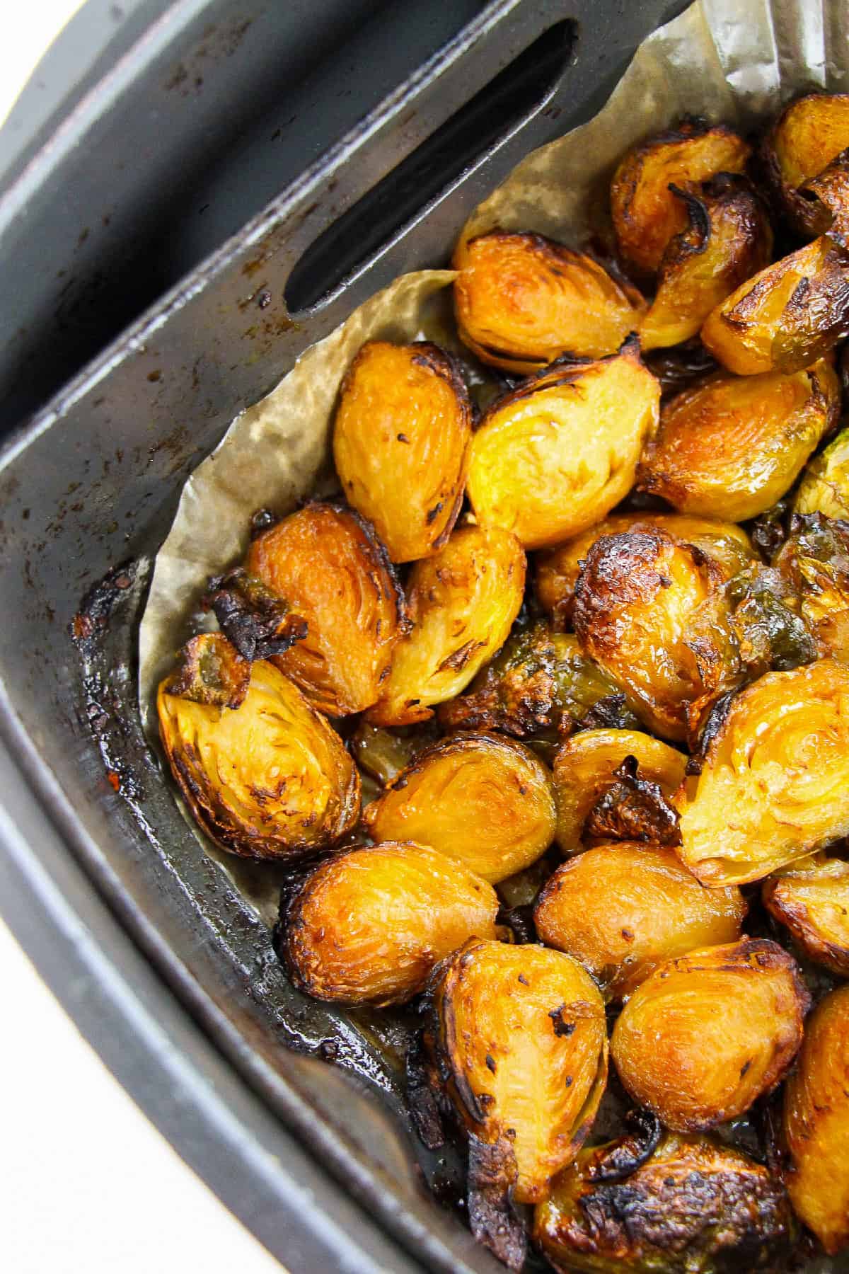 Close-up of caramelized air fryer Brussels sprouts cooked to a golden-brown finish.