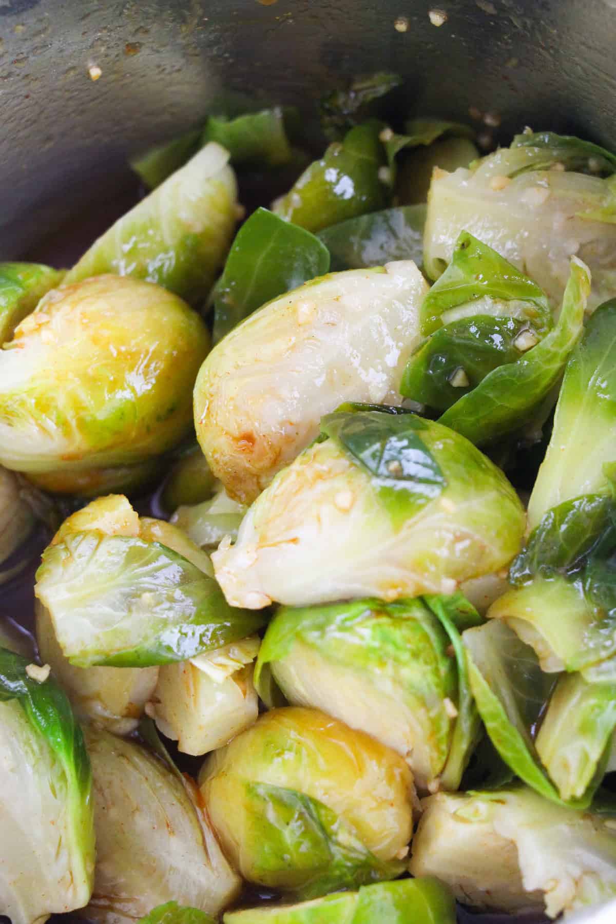 Close-up of Brussels sprouts coated in gochujang garlic sauce.