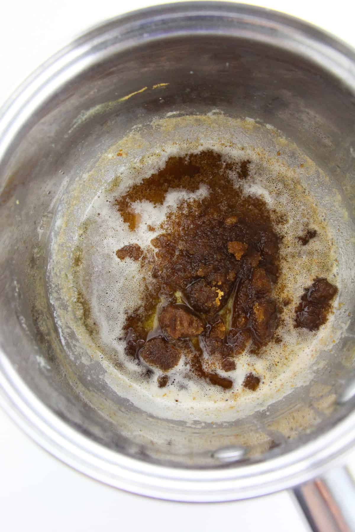 Melted butter and brown sugar mixture in a saucepan for Korean Brussels sprouts.