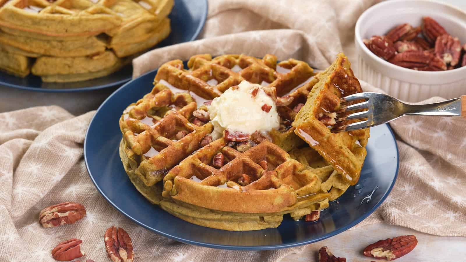 Pumpkin pecan waffles with syrup.