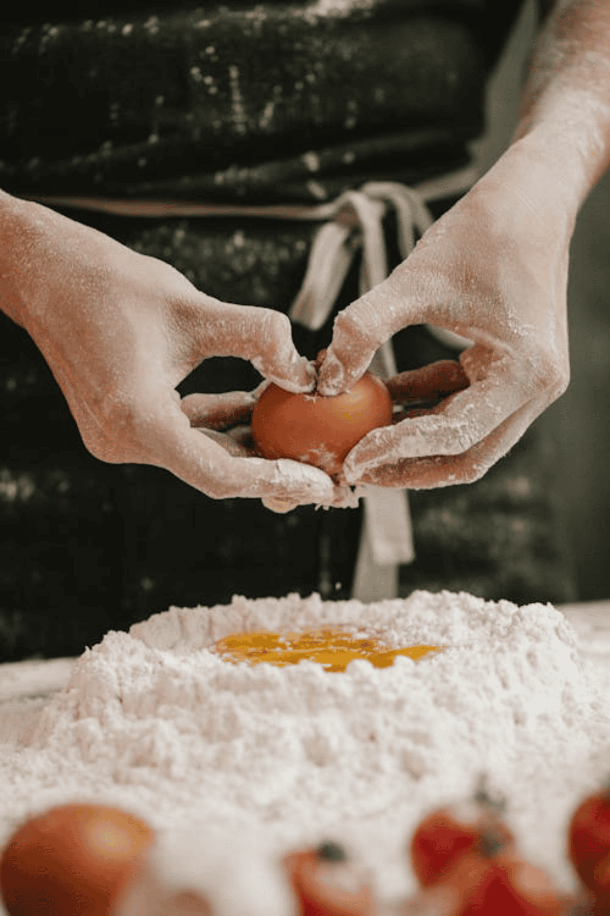 Flour on a table with an egg ready for baking.