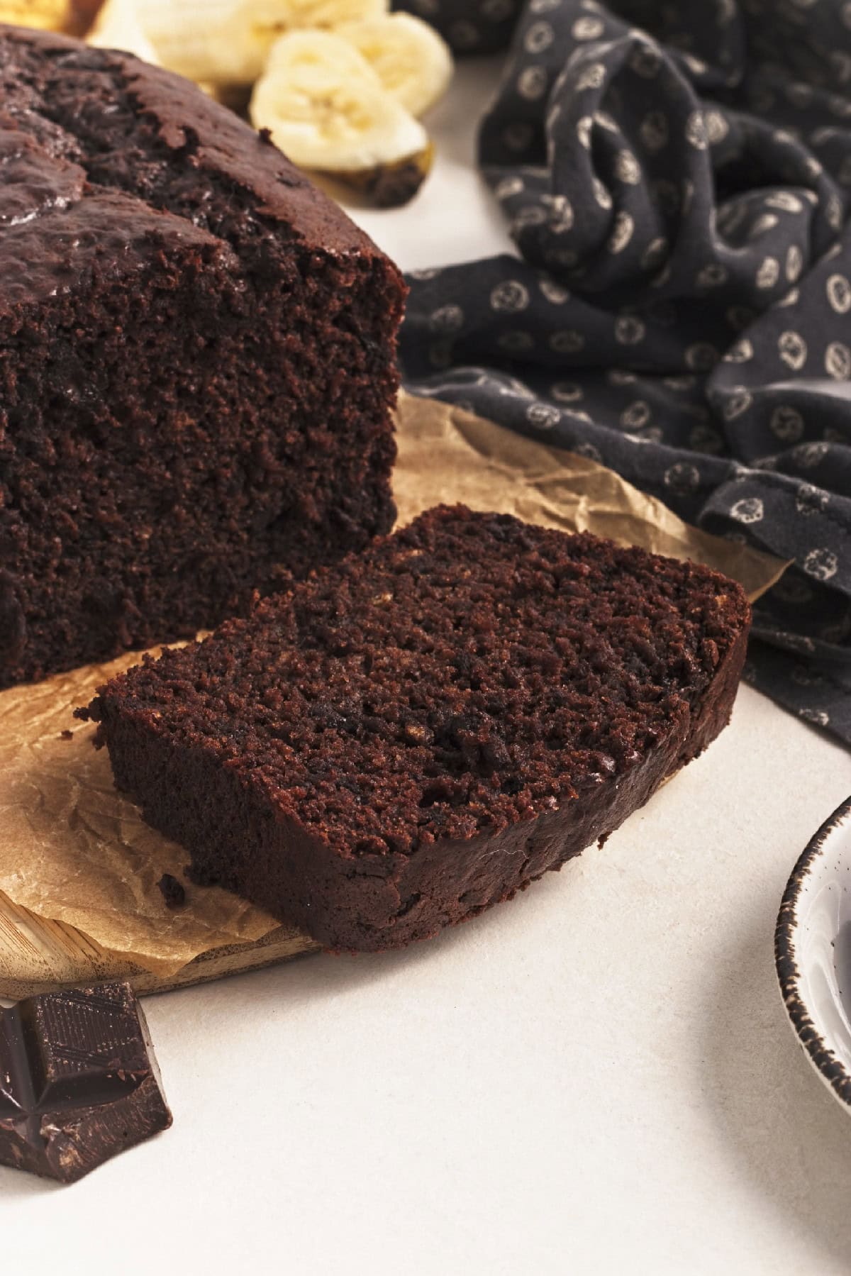 Close-up of moist vegan chocolate banana bread slice showing rich texture.