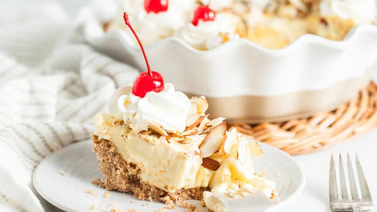 Amaretto cream pie in an almond crust topped with whipped cream and nuts.