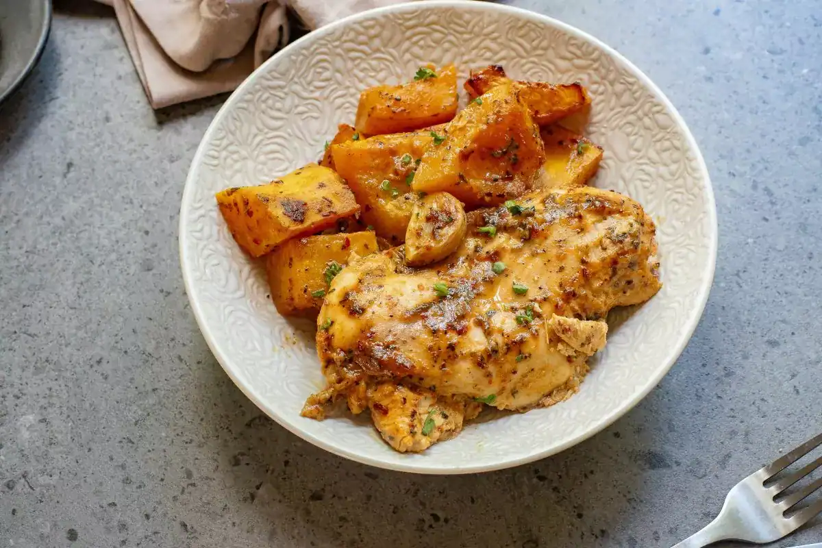 Simple sheet pan chicken breasts with vegetables.