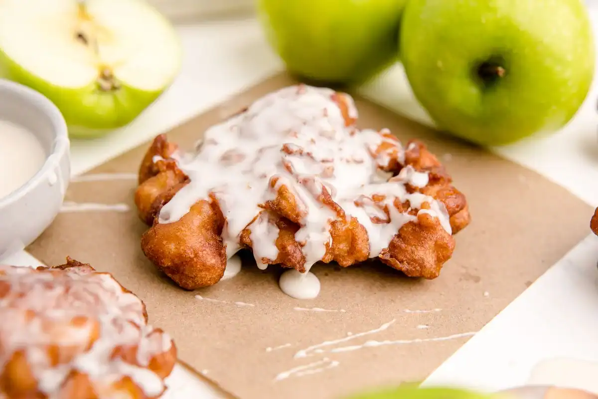 Apple cinnamon fritters coated in glaze.