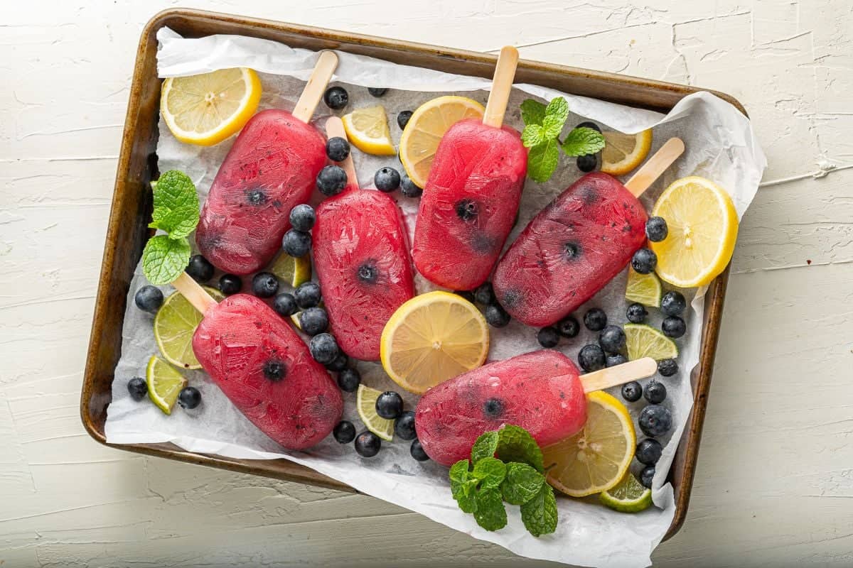 Blueberry lemonade popsicles on sticks.