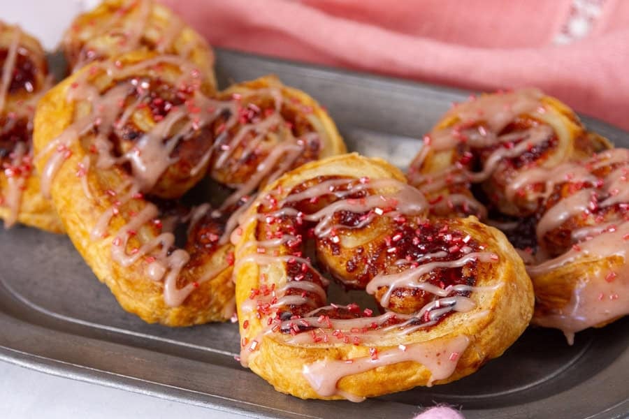 Flaky puff pastry hearts dusted with sugar for a light, sweet snack.
