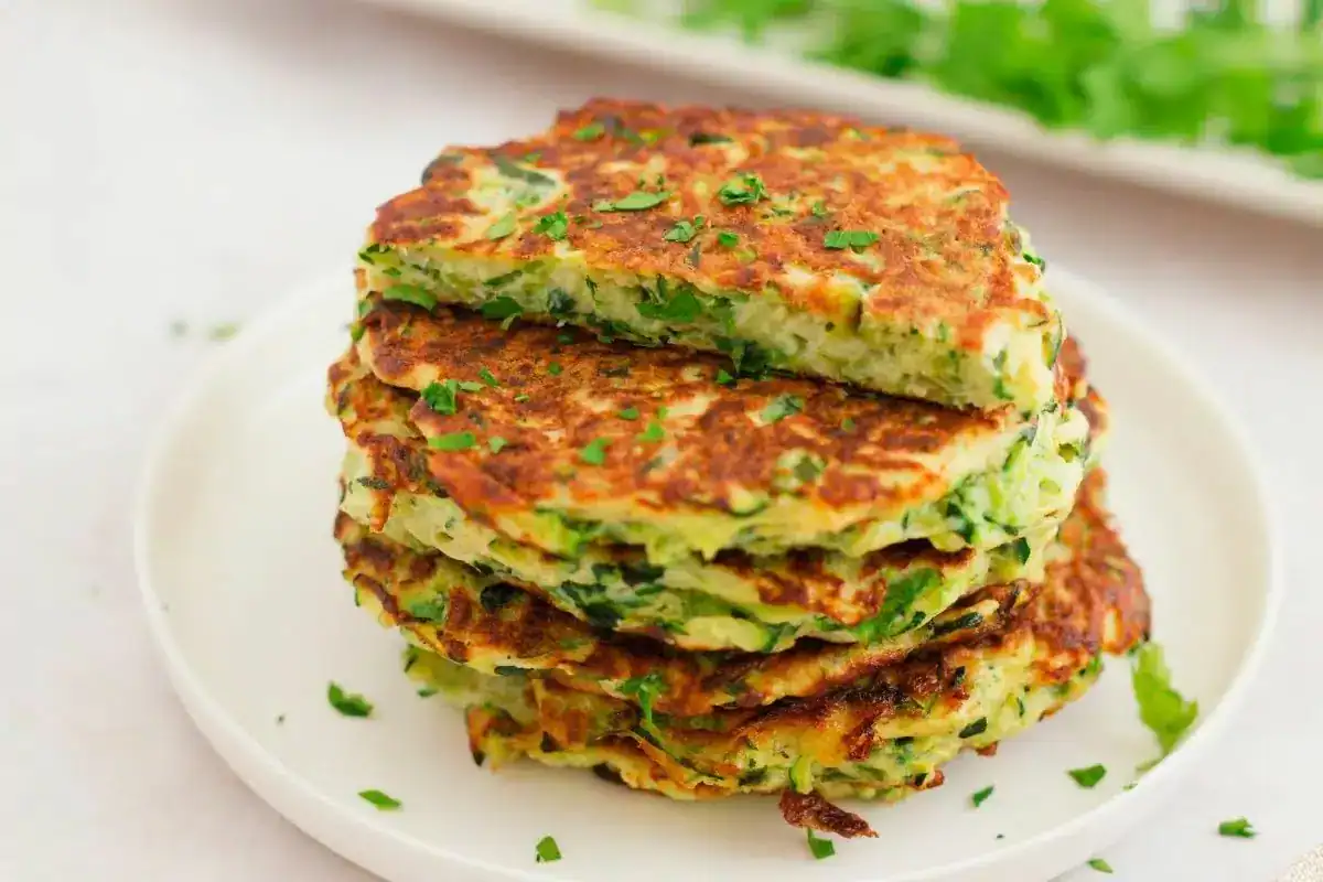 Stack of golden zucchini fritters.