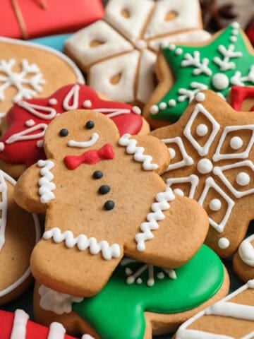 Assorted festive Christmas cookies decorated with colorful icing, including gingerbread men, snowflakes, stars, and candy cane shapes.