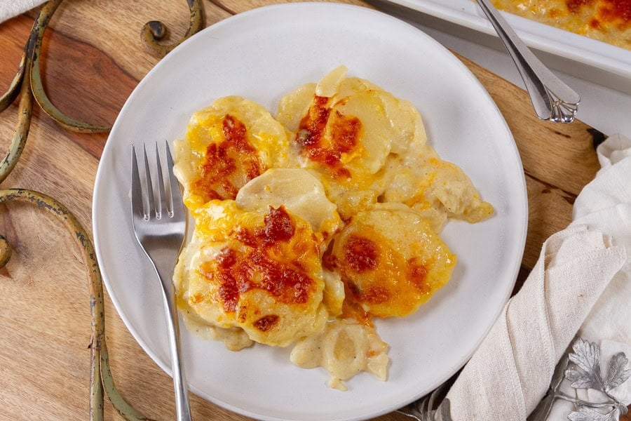 Thin potato slices baked with cheddar cheese sauce.