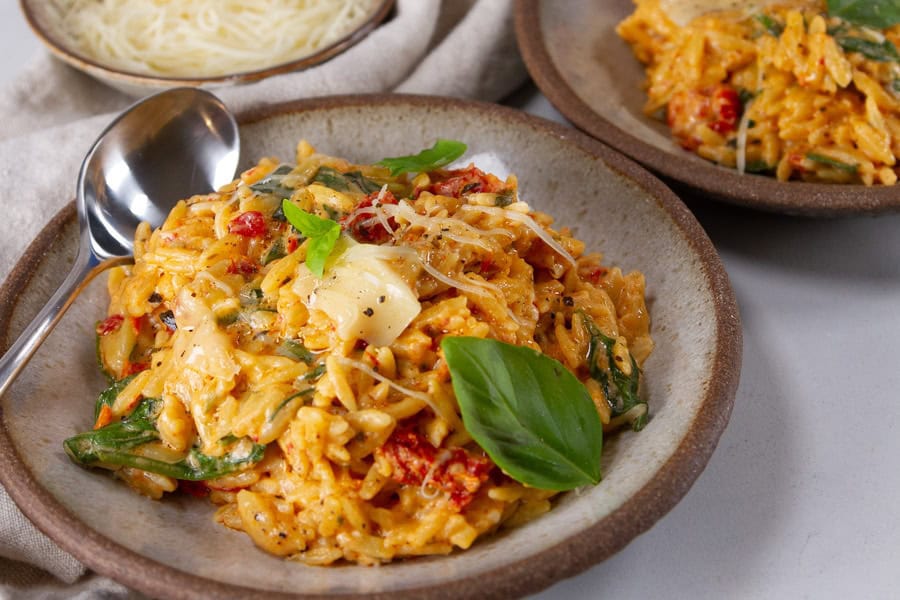 Baked orzo with spinach, sun-dried tomatoes, and cheese.