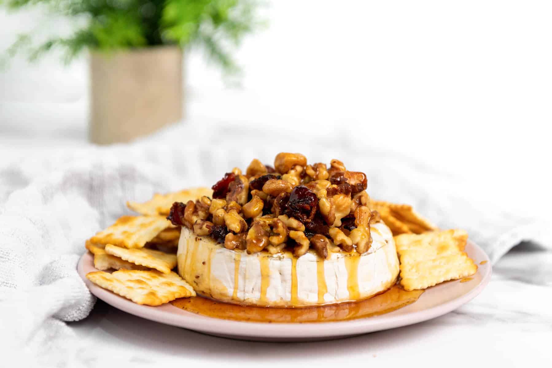 Savory baked brie topped with bacon, walnuts, and warm honey.