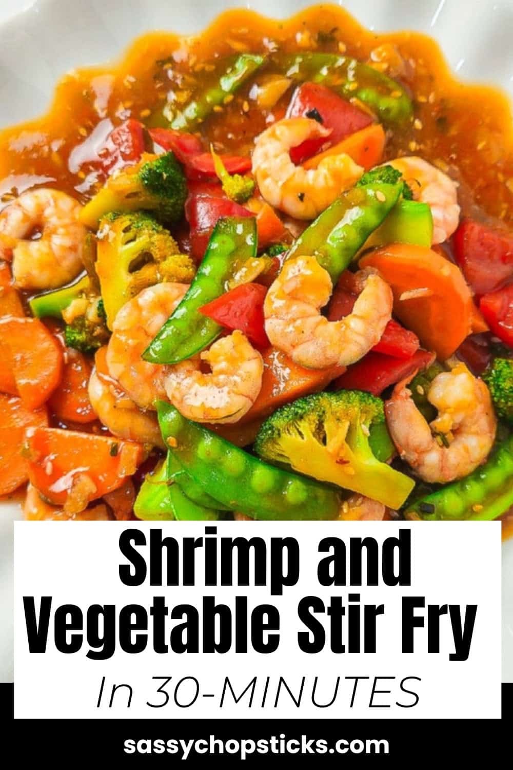 A colorful shrimp stir-fry served on a white scalloped plate, featuring plump shrimp, bright broccoli florets, snow peas, carrots, and red bell peppers.