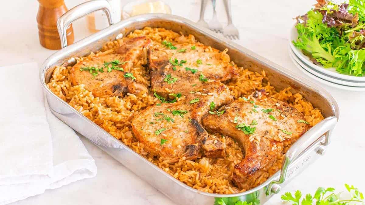 Baked pork chop and rice casserole in a dish.