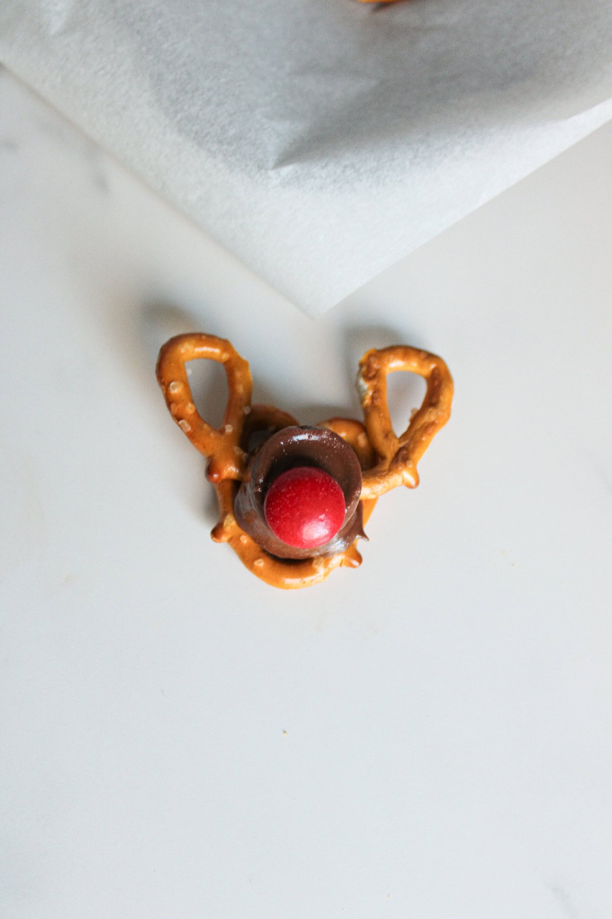 A red candy piece pressed onto the front of the Rolo chocolate to create Rudolph's signature red nose.